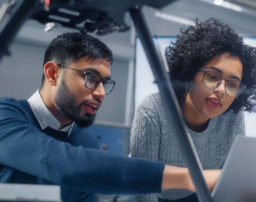 Two people looking at a computer screen.