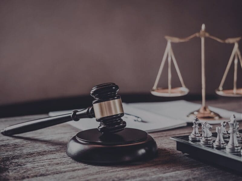 Gavel, scales of justice, and chess pieces