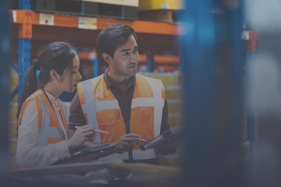 Workers speaking inside an industrial facility