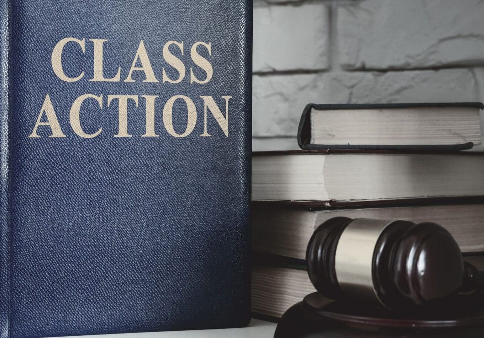 Class action book beside gavel and books